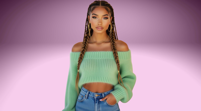 A beautiful Black fashion model with long multi-color braids wearing a soft off-the-shoulder sweater and jeans